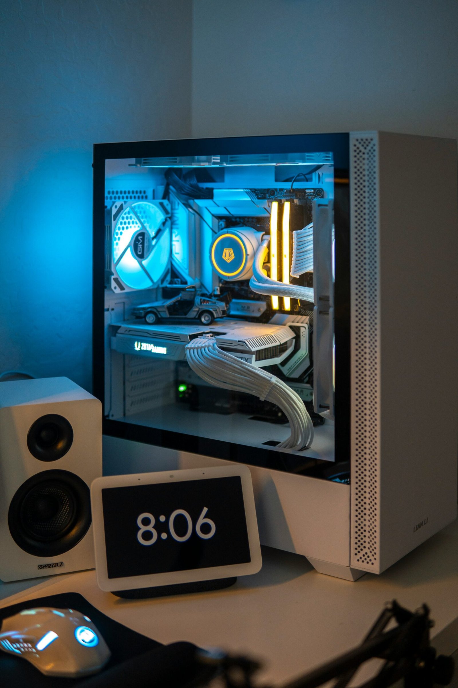 a desktop computer with a clock and speakers